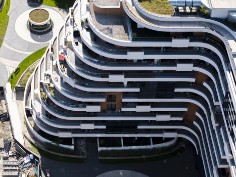 Aerial view of a modern residential building with curved balconies and green roof terraces in Krakow Lesser Poland Voivode Poland.
