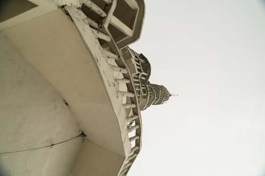 View of the spiral structure and white balconies of Ambuluwawa Tower reaching toward the sky in Gampola Central Province Sri Lanka. View of the spiral structure and white balconies of Ambuluwawa Tower reaching toward the sky in Gampola Central Province Sri Lanka.