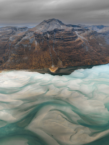 Aerial view of the rugged mountains and turquoise tidal sandbanks of Senja Troms Norway.