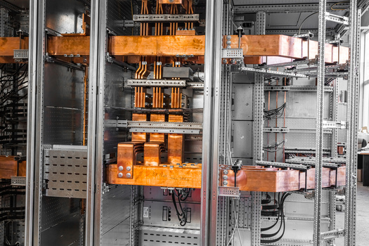 View of industrial electrical switchgear cabinet with copper busbars and wiring in Latvia. View of industrial electrical switchgear cabinet with copper busbars and wiring in Latvia.