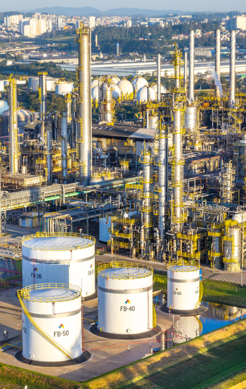 Aerial view of the petrochemical complex featuring large storage tanks industrial distillation towers and complex piping systems in Santo Andre Sao Paulo Brazil.