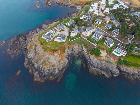 Aerial view of Arapya featuring modern villas with swimming pools situated on rocky cliffs overlooking the Black Sea in Burgas Bulgaria. Aerial view of Arapya featuring modern villas with swimming pools situated on rocky cliffs overlooking the Black Sea in Burgas Bulgaria.