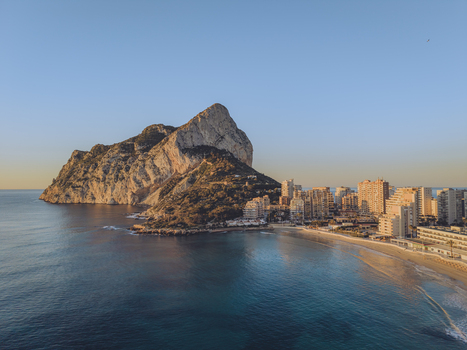 Aerial view of the Penyal d Ifac rock formation rising above the Mediterranean Sea with the coastal town of Calp Valencian Community Spain. Aerial view of the Penyal d Ifac rock formation rising above the Mediterranean Sea with the coastal town of Calp Valencian Community Spain.