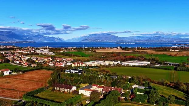 Aerial view of rural landscape and lake in Italy.