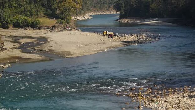 View of a river and a truck on a sandy bank Nepal.