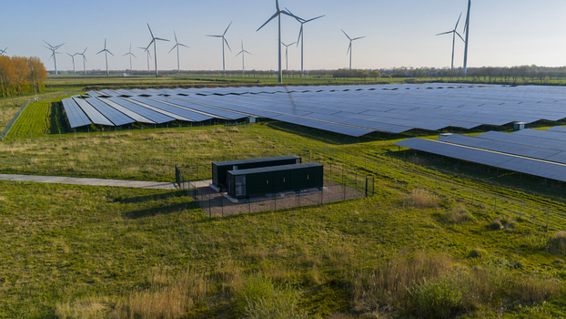 Aerial view of Solar park Delfzijl with rows of photovoltaic panels and wind turbines under a clear blue sky in Farmsum Groningen Netherlands. Aerial view of Solar park Delfzijl with rows of photovoltaic panels and wind turbines under a clear blue sky in Farmsum Groningen Netherlands.