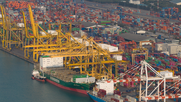 Si Racha District Thailand 08 March 2026 Aerial view of Laem Chabang International Terminal with a large container ship docked under yellow gantry cranes and cargo containers. Si Racha District Thailand 08 March 2026 Aerial view of Laem Chabang International Terminal with a large container ship docked under yellow gantry cranes and cargo containers.