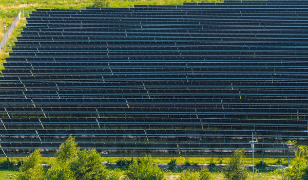 Aerial view of a large solar farm with rows of photovoltaic panels installed in a green field in Gdansk Pomeranian Voivodeship Poland.