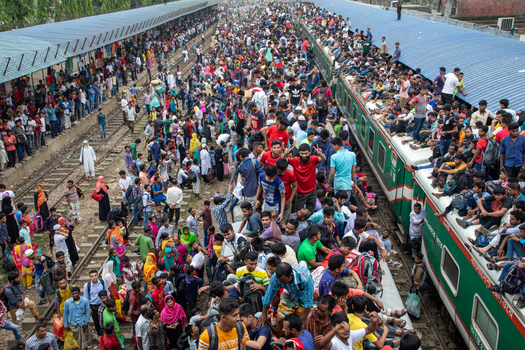 Dhaka Bangladesh 15 June 2018 View of a massive crowd of passengers boarding and sitting on the roof of a train at Airport Railway Station. Dhaka Bangladesh 15 June 2018 View of a massive crowd of passengers boarding and sitting on the roof of a train at Airport Railway Station.