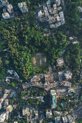 Chattogram Chittagong Division Bangladesh 18 November 2022 Aerial view of the urban landscape in Chattogram featuring dense buildings lush trees and a central field.