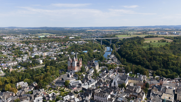 Aerial view of Limburg Cathedral surrounded by historic town buildings lush greenery and the Lahn river in Limburg an der Lahn Hessen Germany. Aerial view of Limburg Cathedral surrounded by historic town buildings lush greenery and the Lahn river in Limburg an der Lahn Hessen Germany.