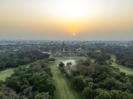Vadodara India 14 March 2026 Aerial view of Laxmi Vilas Palace with its Indo Saracenic architecture surrounded by lush green grounds and a hazy sunset over the city skyline. Vadodara India 14 March 2026 Aerial view of Laxmi Vilas Palace with its Indo Saracenic architecture surrounded by lush green grounds and a hazy sunset over the city skyline.