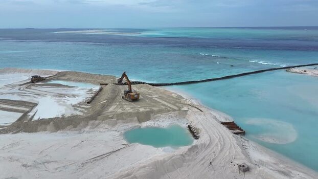 Aerial view of land reclamation and excavators Maldives.