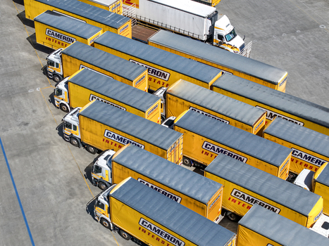 Kilsyth Victoria Australia 20 September 2026 Aerial view of a large fleet of yellow Cameron Interstate semi trucks and trailers parked in a paved logistics yard. Kilsyth Victoria Australia 20 September 2026 Aerial view of a large fleet of yellow Cameron Interstate semi trucks and trailers parked in a paved logistics yard.