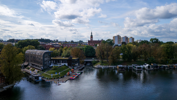 Aerial view of the river reflecting the sky old buildings and the cathedral tower rising above the skyline Bydgoszcz Województwo kujawsko pomorskie Poland. Aerial view of the river reflecting the sky old buildings and the cathedral tower rising above the skyline Bydgoszcz Województwo kujawsko pomorskie Poland.