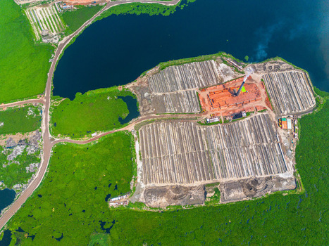 Aerial view of patterns of brick factories and rows of drying bricks contrasting against the lush green surroundings Dhaka Dhaka Division Bangladesh. Aerial view of patterns of brick factories and rows of drying bricks contrasting against the lush green surroundings Dhaka Dhaka Division Bangladesh.