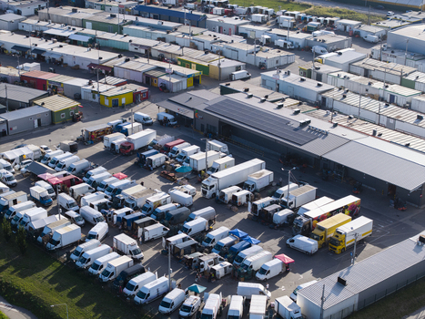 Krakow Poland 16 September 2026 Aerial view of the busy Rybitwy Market featuring rows of warehouses numerous delivery trucks and vans parked in the logistics hub. Krakow Poland 16 September 2026 Aerial view of the busy Rybitwy Market featuring rows of warehouses numerous delivery trucks and vans parked in the logistics hub.