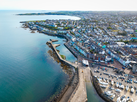 Aerial view of Bangor Harbour and Town featuring colorful buildings a stone pier and boats moored in the marina in Bangor Northern Ireland United Kingdom.