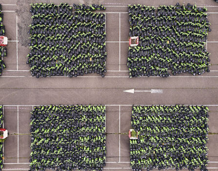 Middenmeer Netherlands 15 June 2026 Aerial view of hundreds of green GO Sharing electric scooters parked in dense blocks on an asphalt lot at a depot in Agriport.