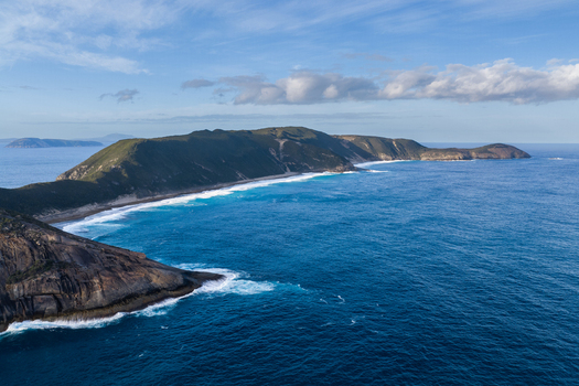 Aerial view of the rugged coastline at Salmon Holes with turquoise waters crashing against rocky cliffs and sandy beaches in Torndirrup Western Australia Australia.