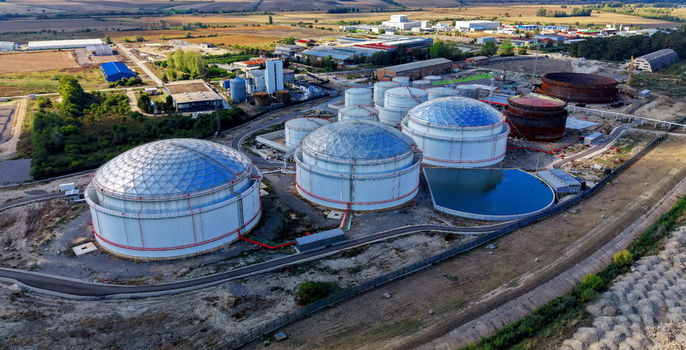 Aerial view of fuel tanks at a storage facility with dome topped structures and a small pond in the industrial area of Kovin Vojvodina Serbia. Aerial view of fuel tanks at a storage facility with dome topped structures and a small pond in the industrial area of Kovin Vojvodina Serbia.
