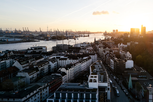Aerial view of Landungsbrucken and the Port of Hamburg with the Elbe river under a golden sunset sky Hamburg Hamburg Germany. Aerial view of Landungsbrucken and the Port of Hamburg with the Elbe river under a golden sunset sky Hamburg Hamburg Germany.