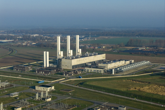 Aerial view of the Nitrogen plant industrial facility featuring tall chimneys and pipes surrounded by green fields in Zuidbroek Groningen Netherlands. Aerial view of the Nitrogen plant industrial facility featuring tall chimneys and pipes surrounded by green fields in Zuidbroek Groningen Netherlands.