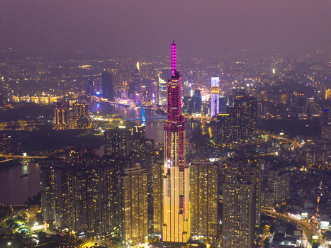 Aerial view of the illuminated Landmark 81 skyscraper and the glowing city skyline at night in Ho Chi Minh City Ho Chi Minh Vietnam. Aerial view of the illuminated Landmark 81 skyscraper and the glowing city skyline at night in Ho Chi Minh City Ho Chi Minh Vietnam.