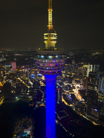 Kuala Lumpur Malaysia 11 March 2026 Aerial view of the illuminated Kuala Lumpur Tower at night with the city skyline and glowing urban lights in the background.