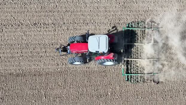 Aerial view of tractor tilling field France.