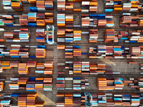 Aerial view of the semi automated container port with rows of colorful shipping containers and automated storage yard in Vado Ligure Liguria Italy. Aerial view of the semi automated container port with rows of colorful shipping containers and automated storage yard in Vado Ligure Liguria Italy.
