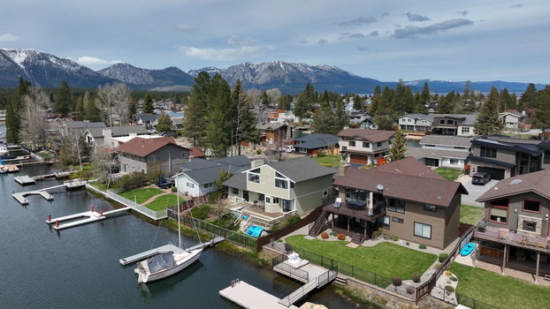 Aerial view of residential houses with private docks and boats along the waterfront in South Lake Tahoe California United States.