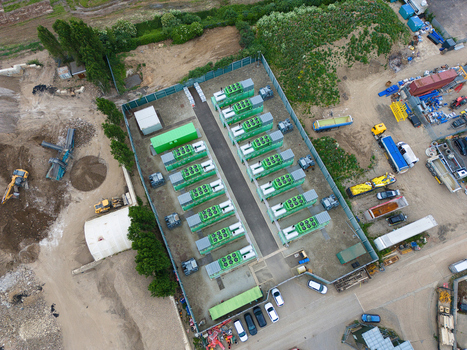 Aerial view of the Damhead Creek Power Station Battery Energy Storage Systems BESS with rows of green battery units in a fenced industrial site Rochester England United Kingdom. Aerial view of the Damhead Creek Power Station Battery Energy Storage Systems BESS with rows of green battery units in a fenced industrial site Rochester England United Kingdom.