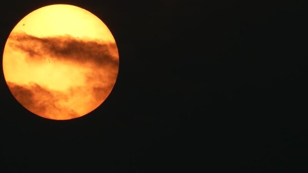 View of the golden sun behind dark clouds Bangladesh.