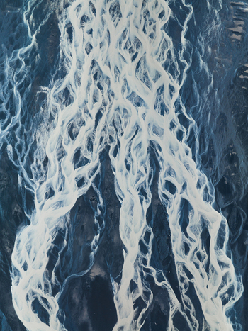 Aerial view of glacial rivers intertwine like veins across the stark landscape creating a mesmerizing contrast of icy white against the dark earth Iceland Iceland. Aerial view of glacial rivers intertwine like veins across the stark landscape creating a mesmerizing contrast of icy white against the dark earth Iceland Iceland.