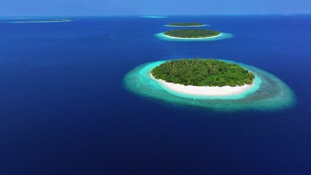 Aerial view of tropical islands and turquoise water in the Maldives. Aerial view of tropical islands and turquoise water in the Maldives.