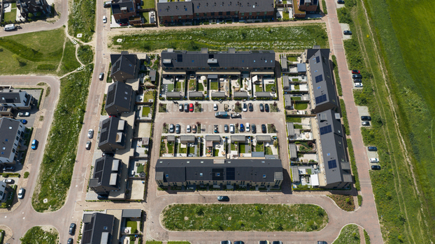 Aerial view of Ecodorp Zuiderveld residential complex featuring modern houses with solar panels private gardens and a central parking area in Nijmegen Gelderland Netherlands. Aerial view of Ecodorp Zuiderveld residential complex featuring modern houses with solar panels private gardens and a central parking area in Nijmegen Gelderland Netherlands.