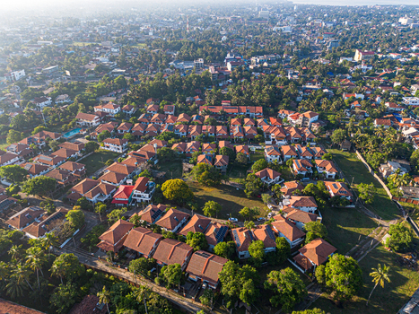 Aerial view of a residential neighborhood featuring red tiled roofs and lush greenery in Negombo Western Province Sri Lanka. Aerial view of a residential neighborhood featuring red tiled roofs and lush greenery in Negombo Western Province Sri Lanka.