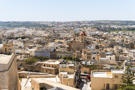 View of the traditional limestone architecture and the parish church dome in the town of Zebbug Gozo Region Malta. View of the traditional limestone architecture and the parish church dome in the town of Zebbug Gozo Region Malta.