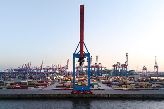 Hamburg Germany 09 March 2026 Aerial view of HHLA Container Terminal Burchardkai CTB with massive gantry cranes and stacks of colorful shipping containers under a clear sky. Hamburg Germany 09 March 2026 Aerial view of HHLA Container Terminal Burchardkai CTB with massive gantry cranes and stacks of colorful shipping containers under a clear sky.