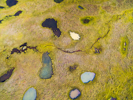 Abstract aerial view of colourful ponds in stony grassland Modrudalsoraefi highlands of Iceland