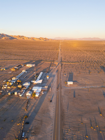 Amboy United States 06 April 2026 Aerial view the lonely route 66 slicing through the arid desert landscape the setting sun casting long shadows over the scattered buildings of the iconic Roy s Motel and Cafe Amboy United States 06 April 2026 Aerial view the lonely route 66 slicing through the arid desert landscape the setting sun casting long shadows over the scattered buildings of the iconic Roy s Motel and Cafe