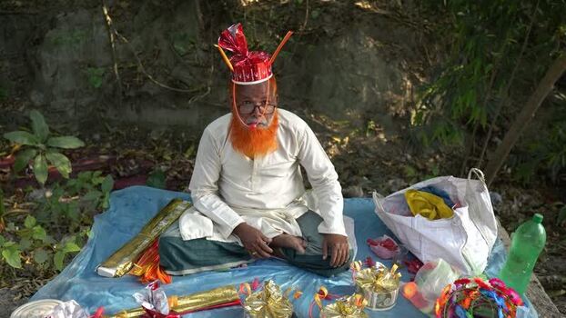 View of a man with an orange beard and a red hat in Bangladesh.