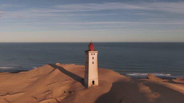 Aerial view of Rubjerg Knude lighthouse on sand dunes Denmark.