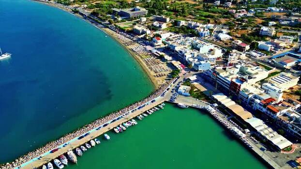 Aerial view of the coastal harbor and beach in Crete Greece.