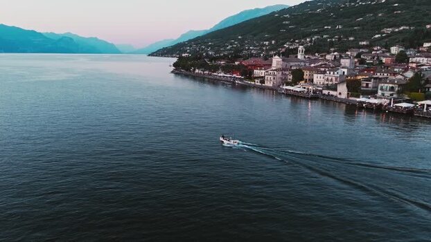 Aerial view of a boat on Lake Garda at dusk Italy. Aerial view of a boat on Lake Garda at dusk Italy.