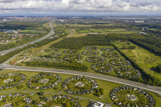 Aerial view of the Brondby Haveby circular garden communities with lush green hedges and small houses near a highway Brondby Denmark. Aerial view of the Brondby Haveby circular garden communities with lush green hedges and small houses near a highway Brondby Denmark.