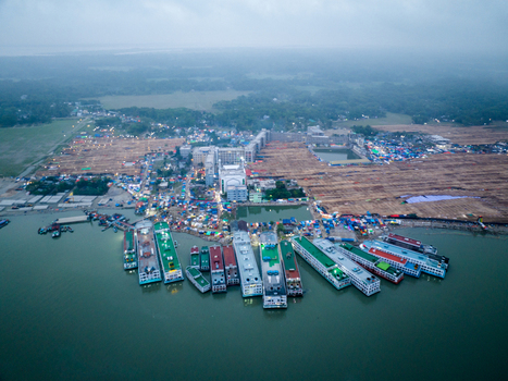 Aerial view of boats moored along the riverbank contrasting with the dense settlement inland Charmonai Barisal Division Bangladesh. Aerial view of boats moored along the riverbank contrasting with the dense settlement inland Charmonai Barisal Division Bangladesh.