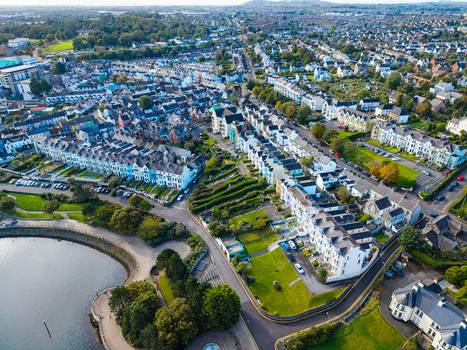 Aerial view of Bangor Harbour and Town with historic terraced houses green gardens and coastal scenery in Bangor Northern Ireland United Kingdom.