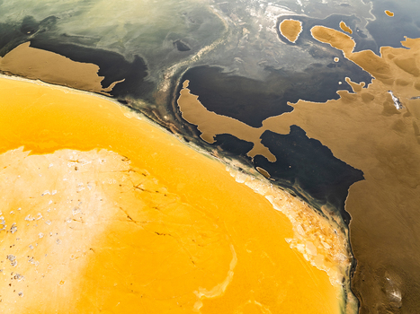 Aerial view of the rugged volcanic landscape with vibrant yellow sulfurous deposits contrasting against dark basaltic rock in Reykjanesbaer Iceland. Aerial view of the rugged volcanic landscape with vibrant yellow sulfurous deposits contrasting against dark basaltic rock in Reykjanesbaer Iceland.